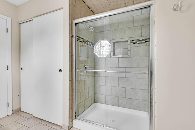 full bathroom with a shower stall and tile patterned floors