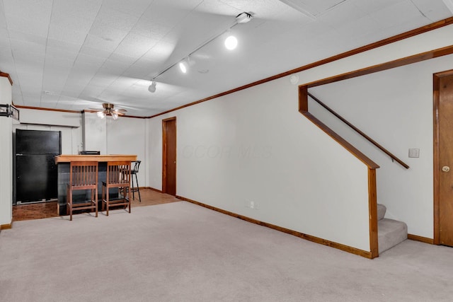 interior space featuring light carpet, stairs, a dry bar, and freestanding refrigerator