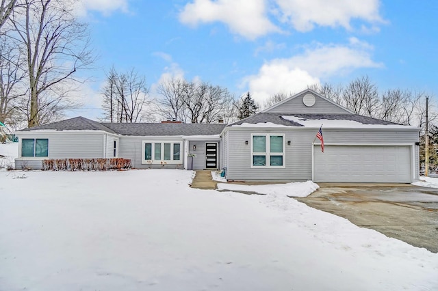 view of front of house featuring concrete driveway and an attached garage