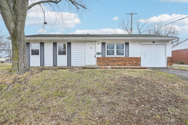 ranch-style house with an attached garage, driveway, a front yard, and brick siding