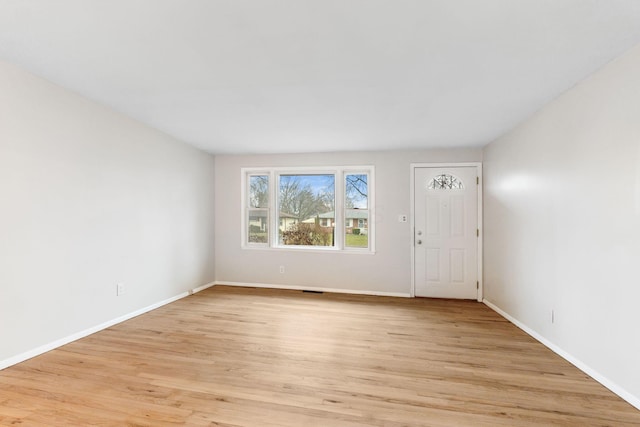 interior space featuring light wood-style flooring, visible vents, and baseboards