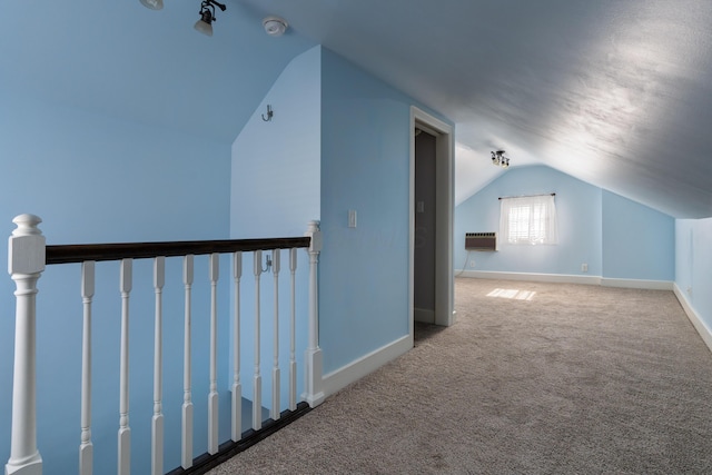 bonus room featuring lofted ceiling, baseboards, carpet flooring, and a wall mounted AC