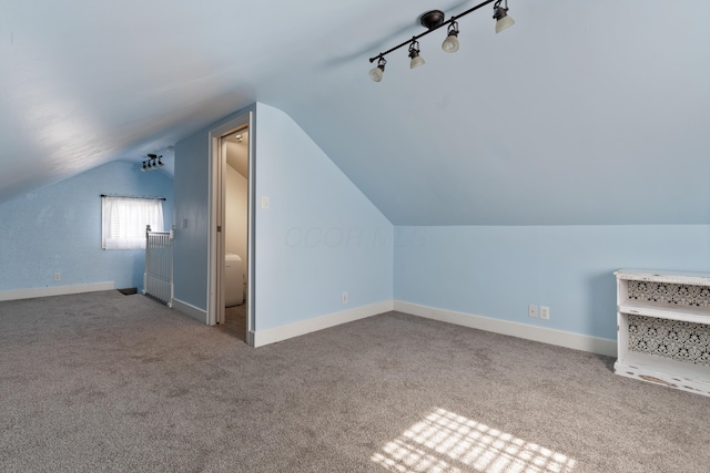 bonus room featuring carpet floors, vaulted ceiling, and baseboards