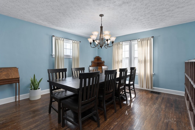 dining room with dark wood-type flooring, a wealth of natural light, and baseboards