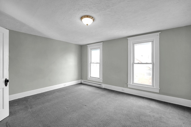 unfurnished room featuring a textured ceiling, dark colored carpet, a baseboard radiator, and baseboards