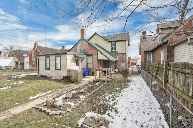 view of front of property featuring a yard, a residential view, fence, and a chimney