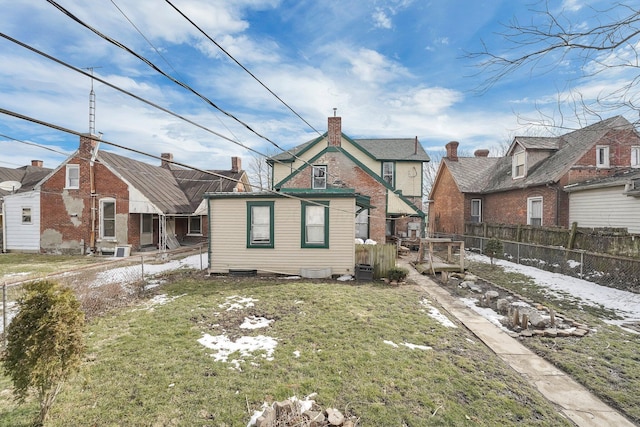 rear view of house featuring a yard, fence, and a residential view