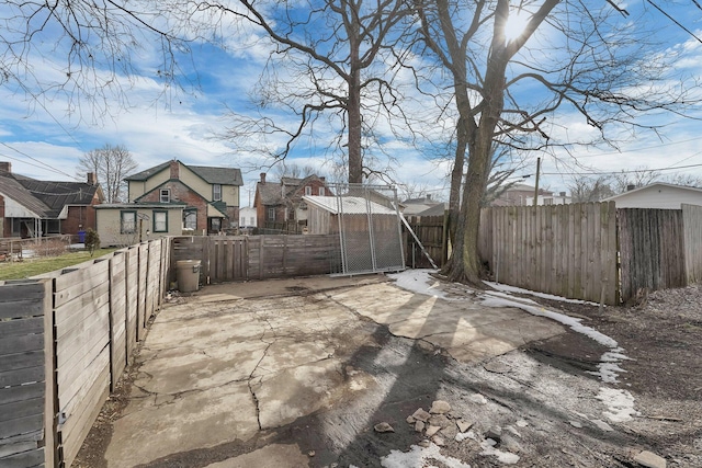 view of patio featuring fence private yard and a residential view