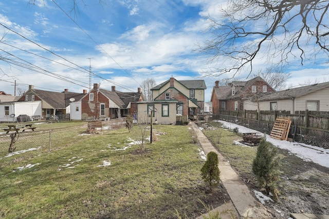 exterior space with a fenced backyard, a residential view, and a front yard