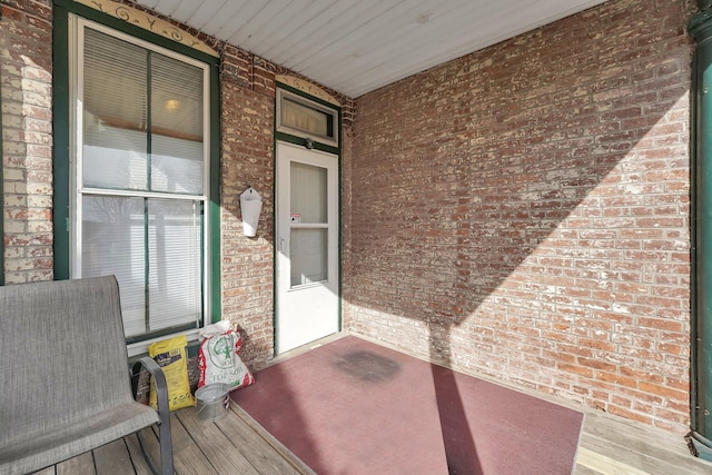 entrance to property with brick siding