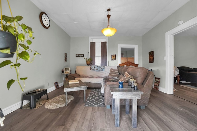 living area featuring baseboards and wood finished floors