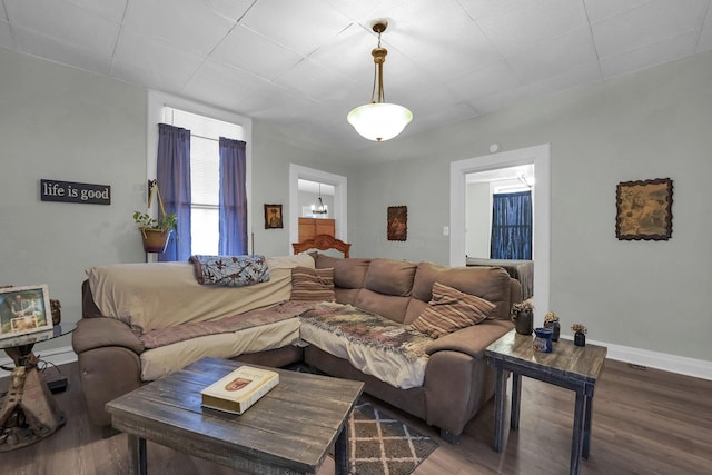 living area featuring baseboards and wood finished floors