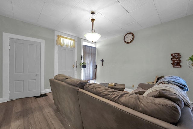 living room featuring dark wood-style flooring and baseboards