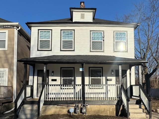 view of front of home featuring a porch and a chimney