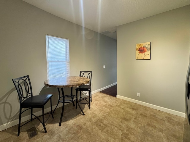 dining room with visible vents and baseboards