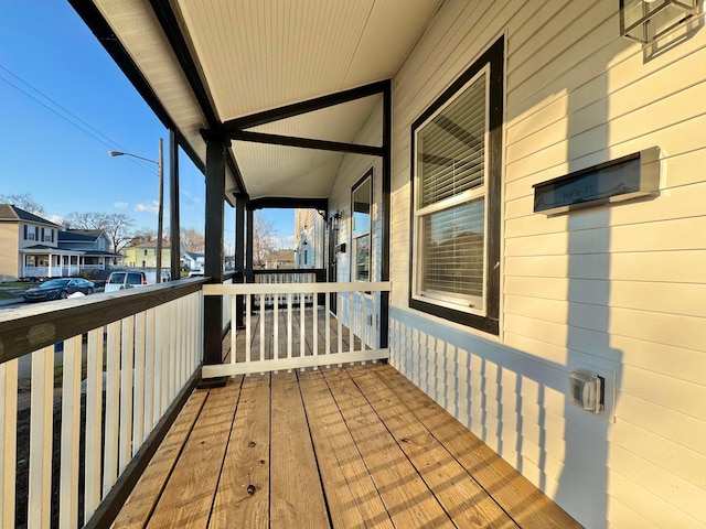 wooden terrace with a porch and a residential view