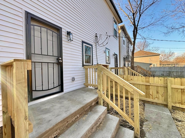 view of exterior entry with fence