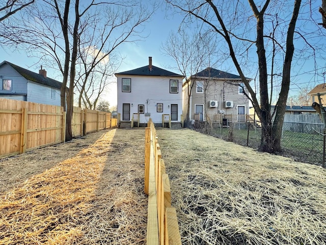 back of property featuring a fenced backyard