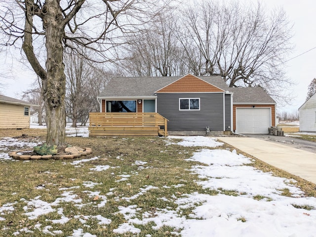 view of front of home with driveway, a shingled roof, and an attached garage