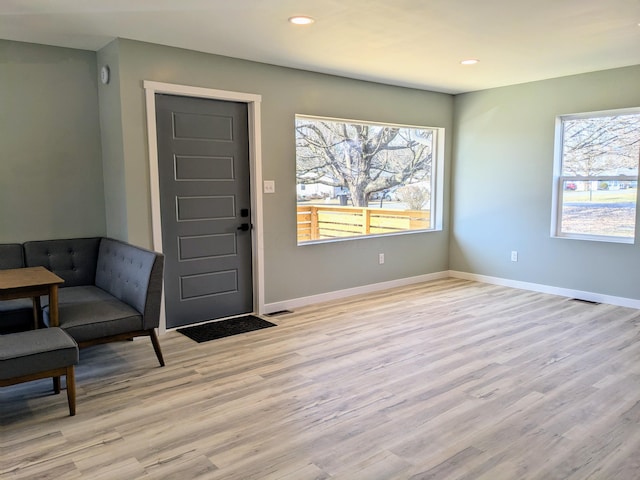 entrance foyer with recessed lighting, light wood-style flooring, and baseboards