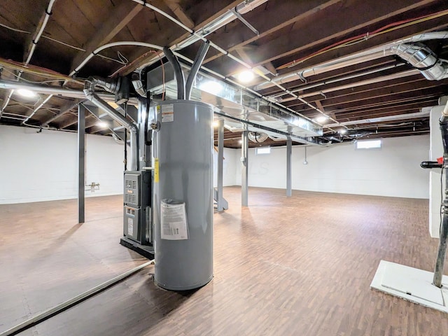 below grade area featuring water heater and wood finished floors