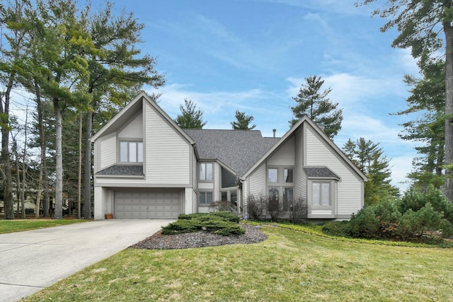 view of front of house with driveway, a front lawn, roof with shingles, and an attached garage