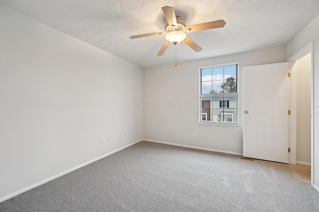 carpeted empty room featuring a textured ceiling, baseboards, and a ceiling fan