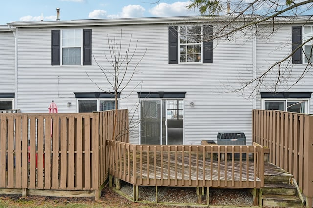 back of house featuring a wooden deck and central air condition unit