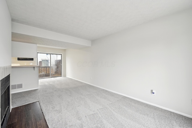 unfurnished living room with baseboards, visible vents, and a multi sided fireplace