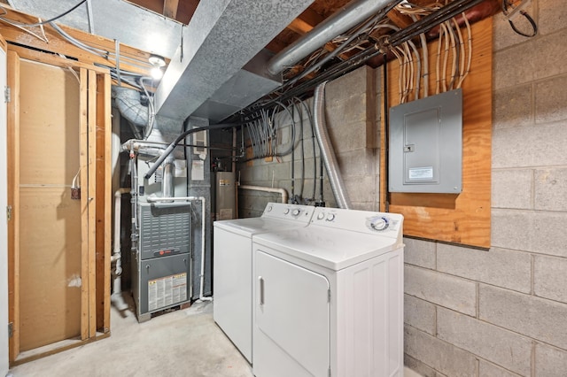 washroom with laundry area, independent washer and dryer, electric panel, and heating unit