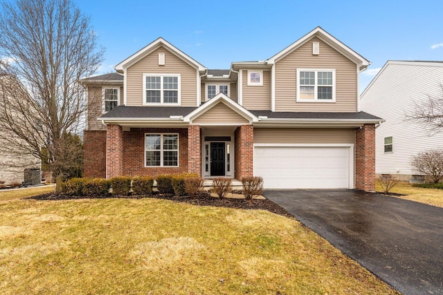 view of front facade with driveway, brick siding, a front lawn, and an attached garage