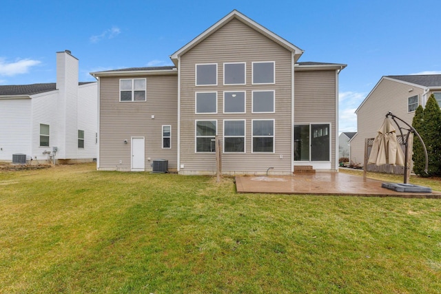 back of property with a patio area, cooling unit, and a lawn