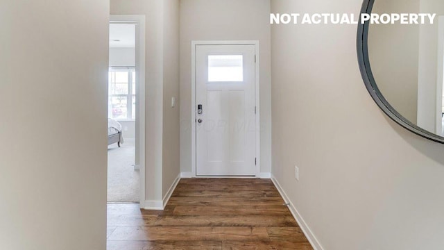 entrance foyer featuring baseboards and wood finished floors