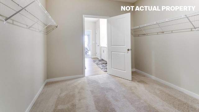 walk in closet with carpet