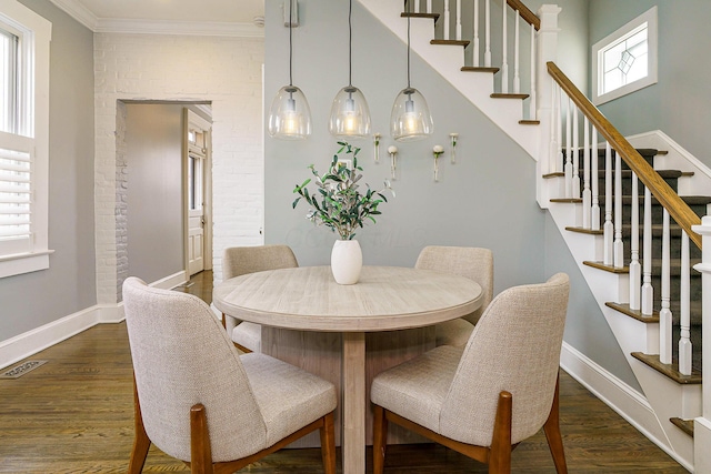 dining space with visible vents, baseboards, stairs, ornamental molding, and dark wood finished floors