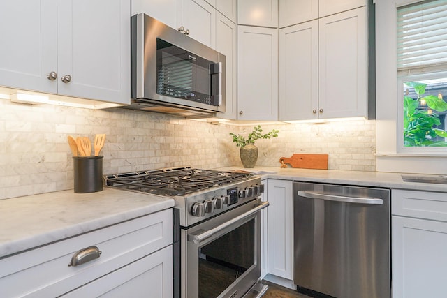 kitchen featuring white cabinetry, tasteful backsplash, and appliances with stainless steel finishes