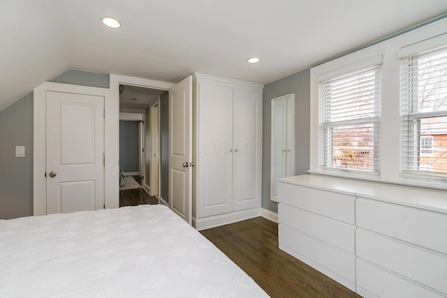 bedroom with recessed lighting, dark wood-style flooring, and vaulted ceiling