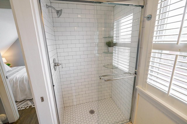 bathroom featuring ensuite bathroom, a shower stall, and a wealth of natural light