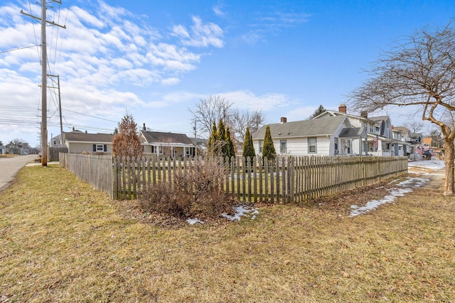 view of yard featuring a fenced front yard and a residential view