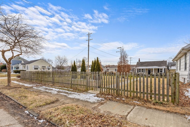 exterior space featuring a fenced front yard and a residential view