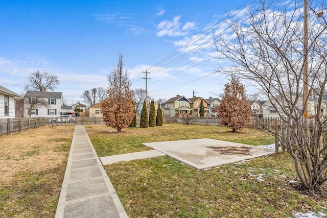 view of yard featuring a fenced backyard and a residential view