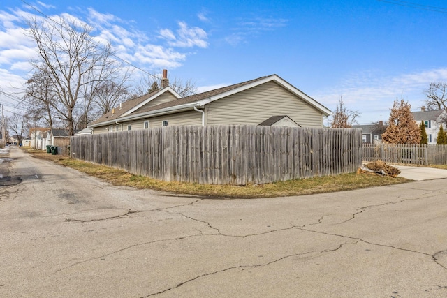 view of property exterior featuring fence