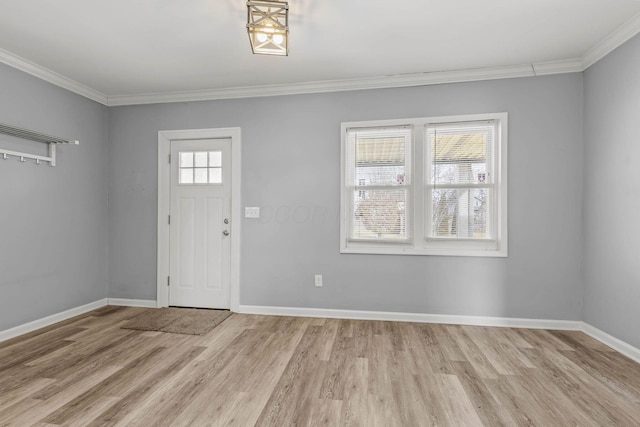 foyer entrance featuring light wood-style flooring, baseboards, and crown molding