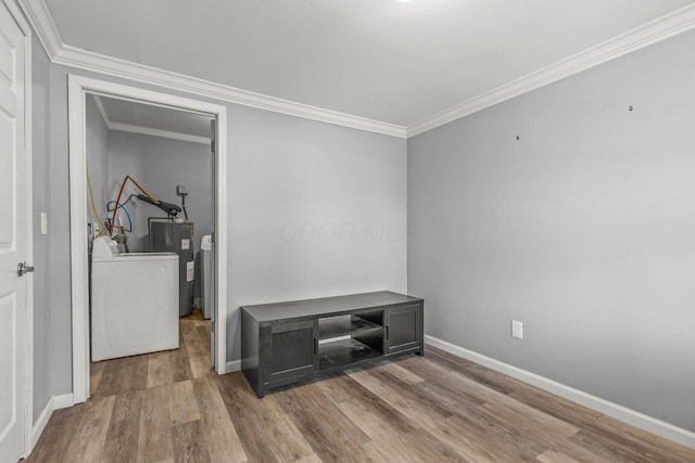 interior space featuring baseboards, water heater, ornamental molding, and wood finished floors