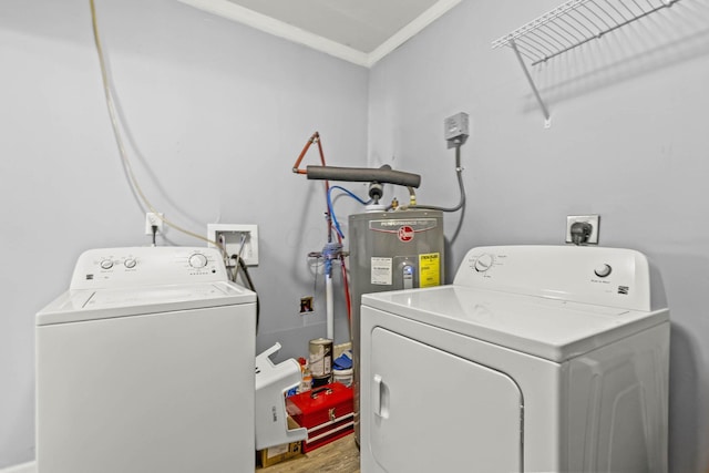 laundry room with ornamental molding, washing machine and dryer, laundry area, and wood finished floors