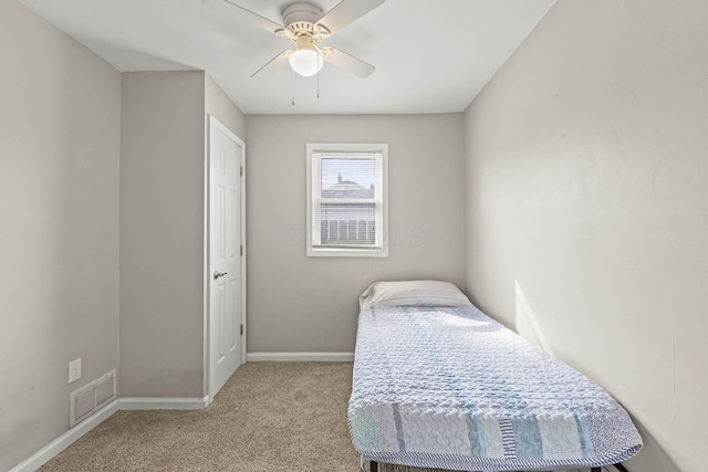 bedroom with baseboards, visible vents, a ceiling fan, and light colored carpet