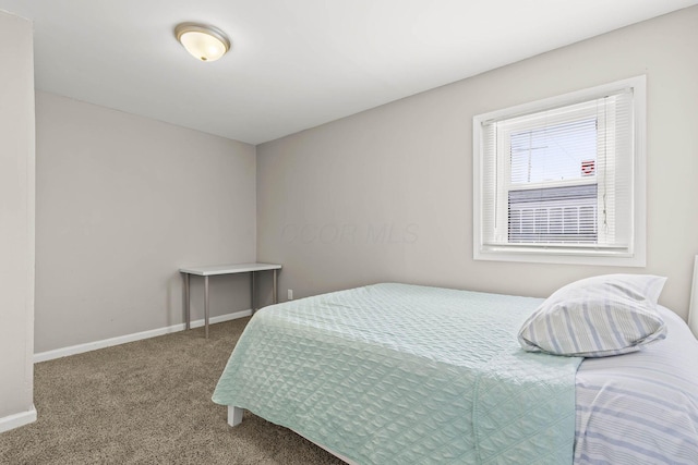 carpeted bedroom with baseboards