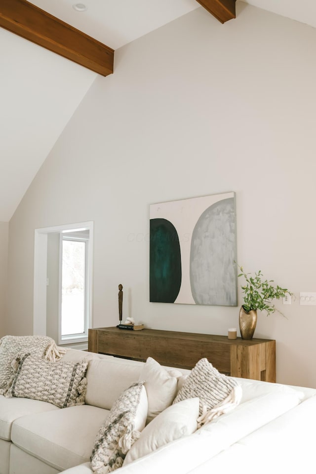 living area with high vaulted ceiling and beamed ceiling