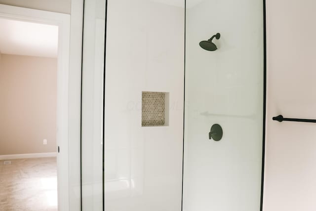 full bathroom featuring baseboards and a walk in shower