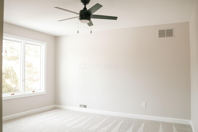 unfurnished room featuring light carpet, plenty of natural light, and visible vents